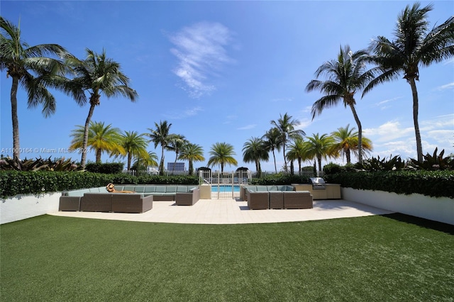 surrounding community featuring a swimming pool, a lawn, and a patio