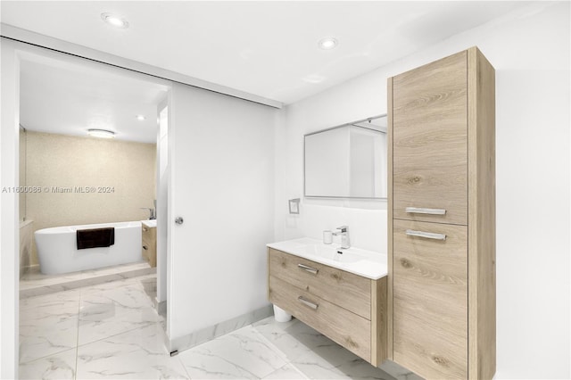 bathroom featuring vanity, tile patterned floors, and a washtub