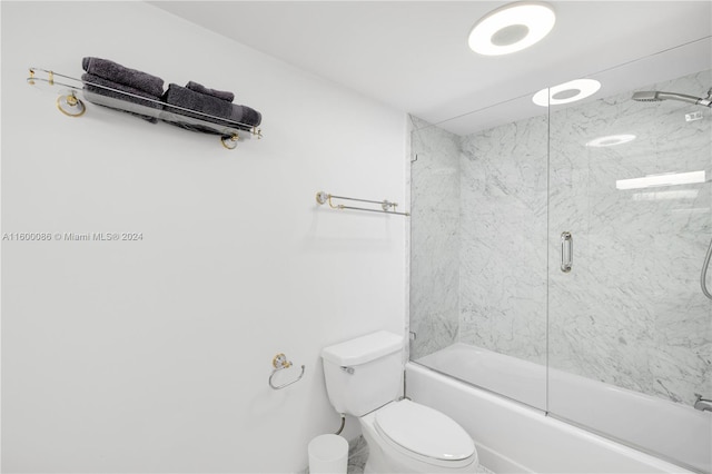 bathroom featuring toilet and enclosed tub / shower combo