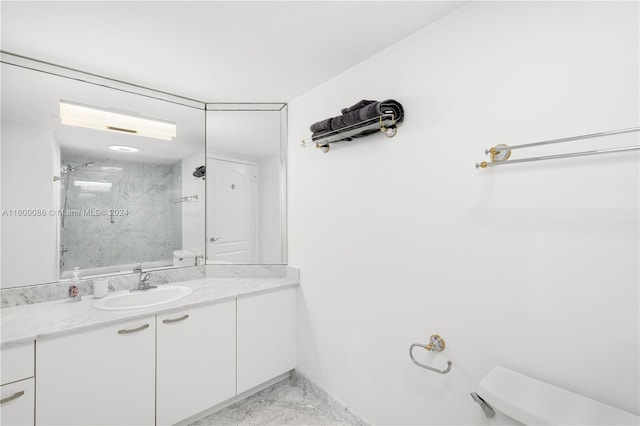 bathroom featuring vanity, toilet, a tile shower, and tile patterned floors