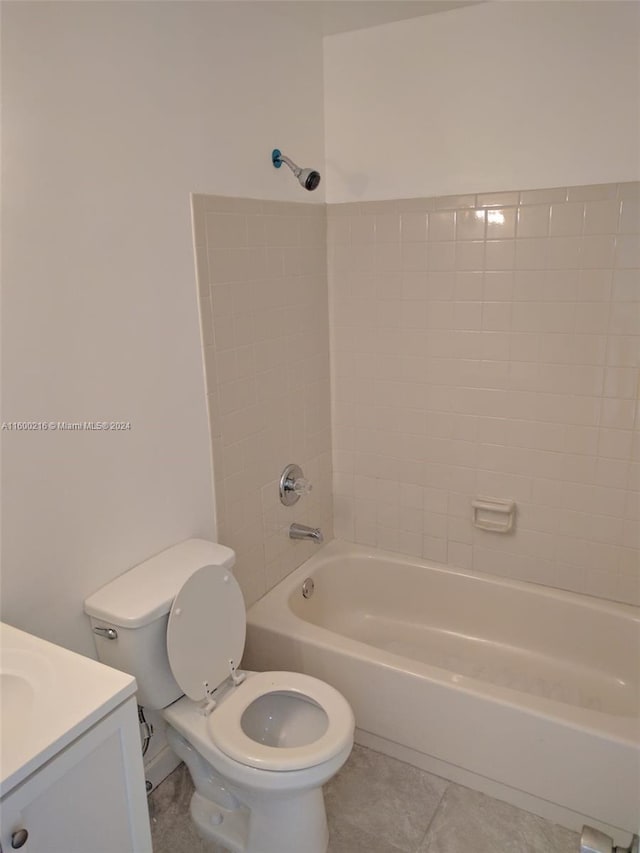 full bathroom with vanity, tile patterned flooring, tiled shower / bath combo, and toilet