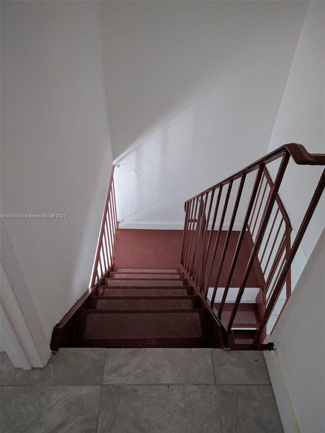 stairway featuring tile patterned floors