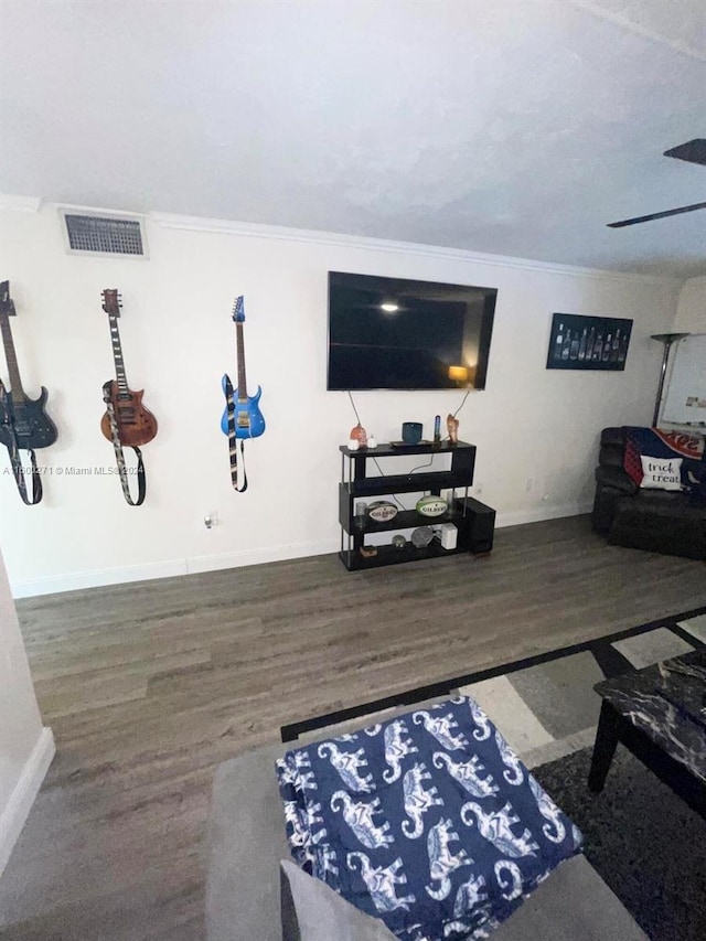 living room with ornamental molding and dark wood-type flooring