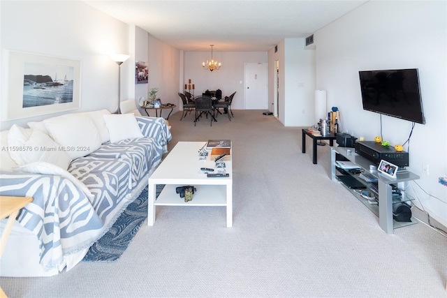 living room featuring light colored carpet and a notable chandelier