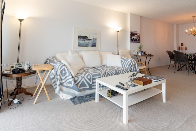 living room featuring an inviting chandelier and carpet floors