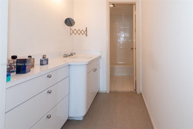 bathroom featuring vanity, tile patterned floors, and tiled shower / bath combo