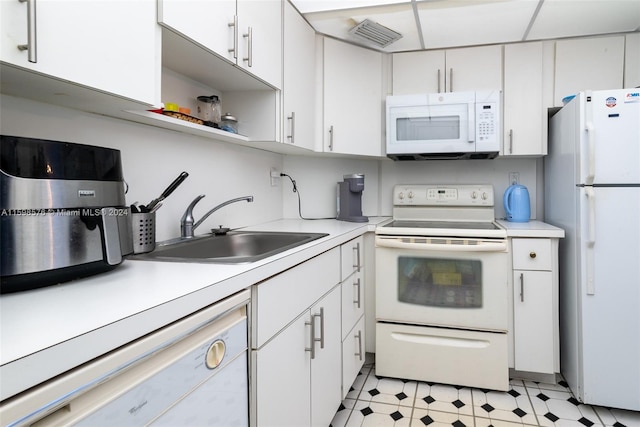 kitchen featuring white cabinetry, sink, and white appliances