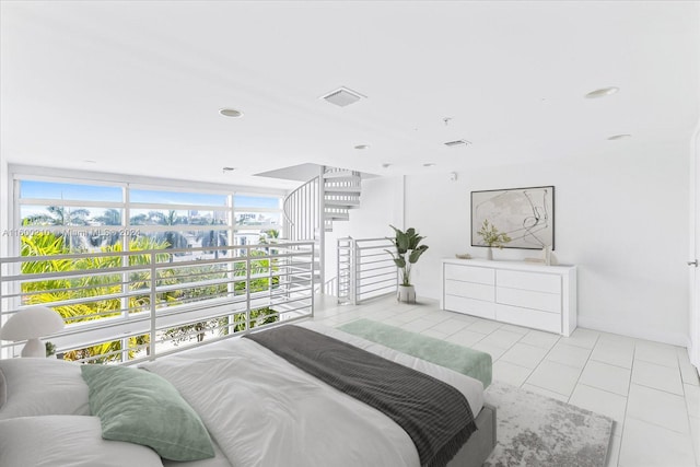 bedroom with light tile patterned flooring and floor to ceiling windows