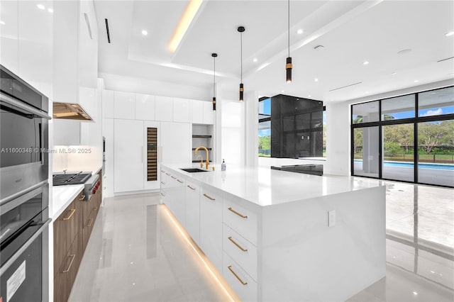 kitchen featuring white cabinets, modern cabinets, and a sink