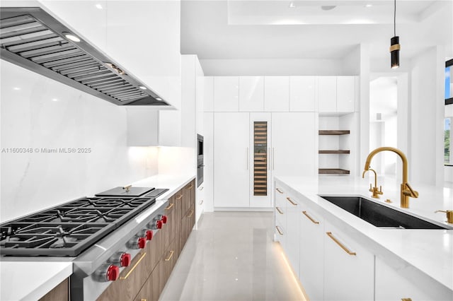 kitchen with stainless steel gas cooktop, modern cabinets, and exhaust hood