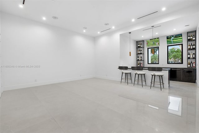 interior space with indoor wet bar, recessed lighting, and baseboards