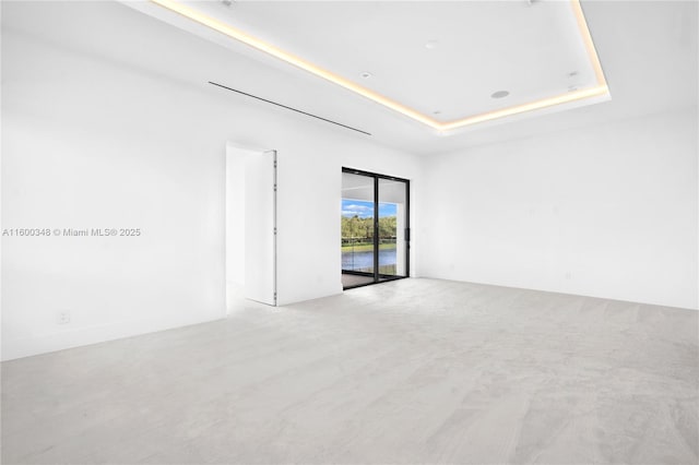 spare room featuring a tray ceiling