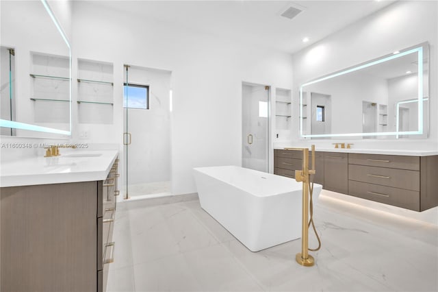 full bath with two vanities, visible vents, a stall shower, and marble finish floor