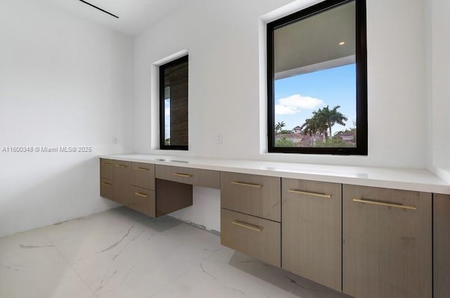 bathroom with marble finish floor and vanity