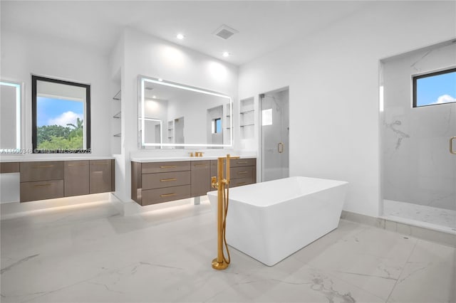 bathroom featuring a marble finish shower, plenty of natural light, and marble finish floor