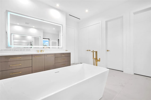 bathroom with visible vents, recessed lighting, a freestanding tub, marble finish floor, and vanity