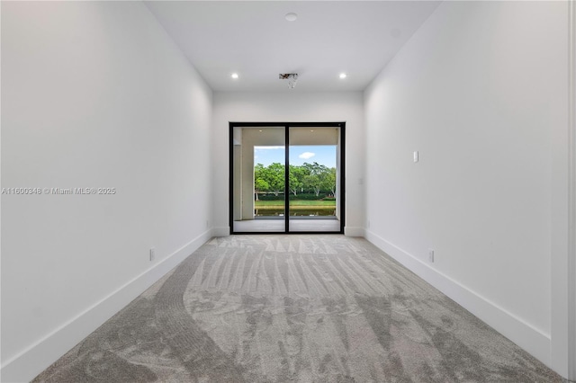 unfurnished room with carpet flooring, recessed lighting, and baseboards