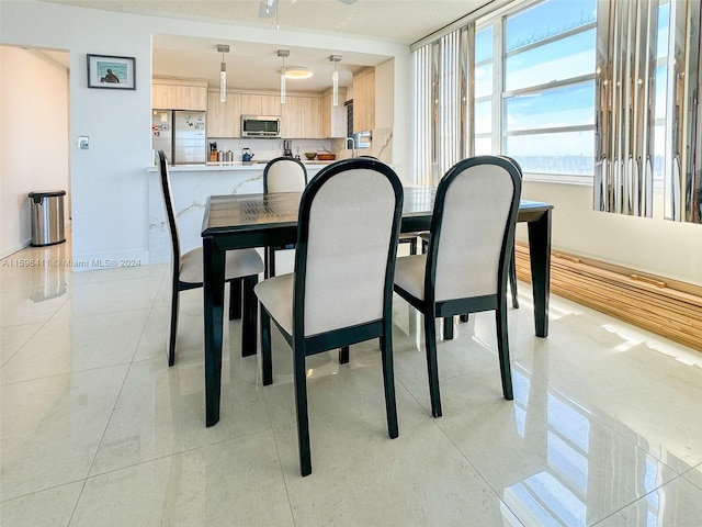 dining area featuring light tile patterned floors