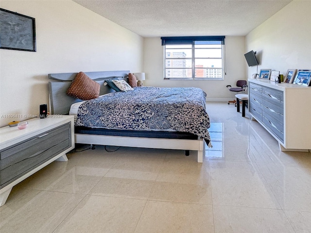 tiled bedroom with a textured ceiling