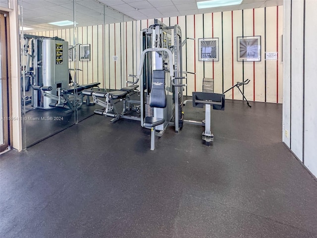 workout area featuring a paneled ceiling