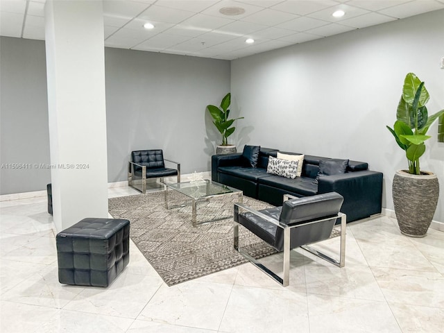 living room featuring a drop ceiling