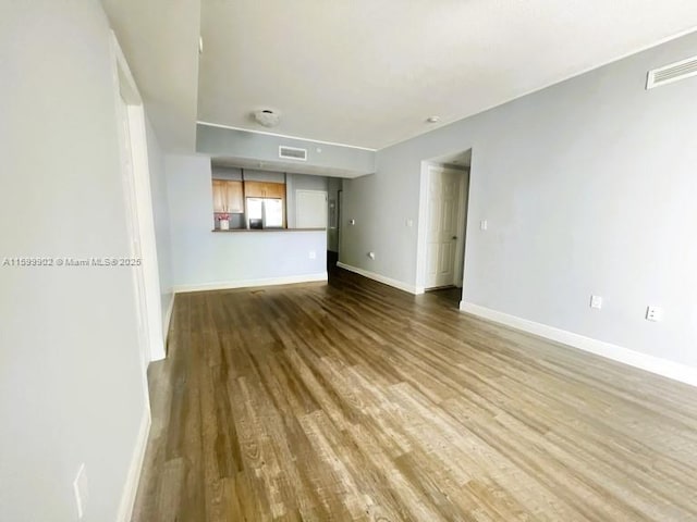 unfurnished living room featuring hardwood / wood-style flooring