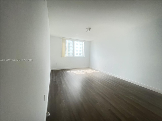 spare room featuring dark hardwood / wood-style floors