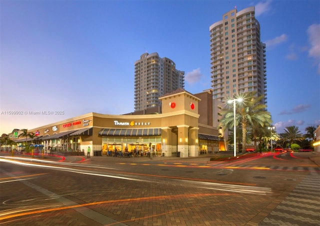 view of outdoor building at dusk