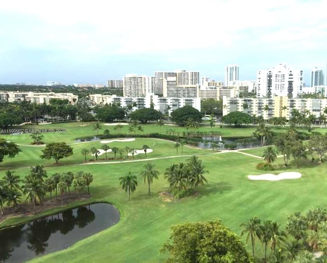 surrounding community with a water view and a lawn