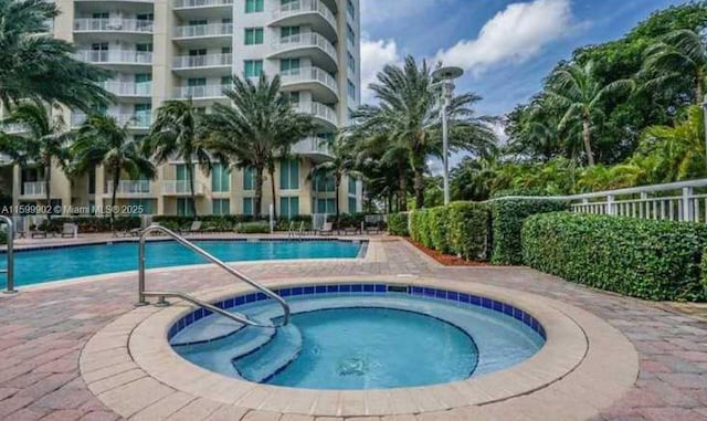 view of pool with a community hot tub