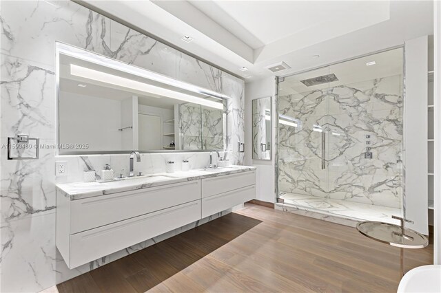 full bathroom featuring hardwood / wood-style floors, vanity, a tray ceiling, plus walk in shower, and toilet