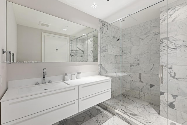 bathroom with a stall shower, marble finish floor, and vanity
