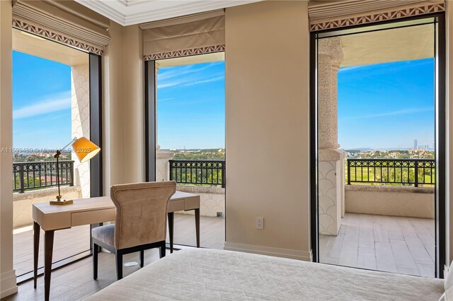 bedroom with crown molding, multiple windows, and light wood-type flooring