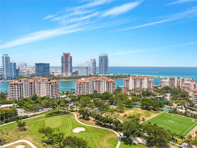 bird's eye view featuring golf course view, a water view, and a city view