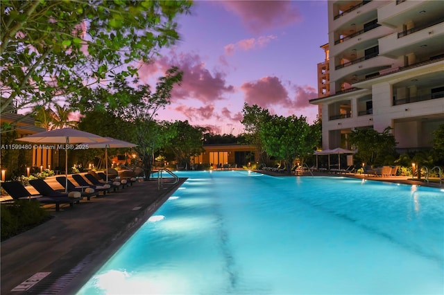 view of pool at dusk