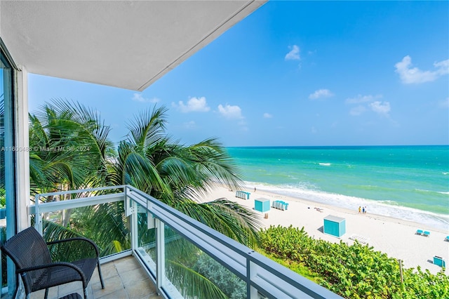 balcony with a beach view and a water view