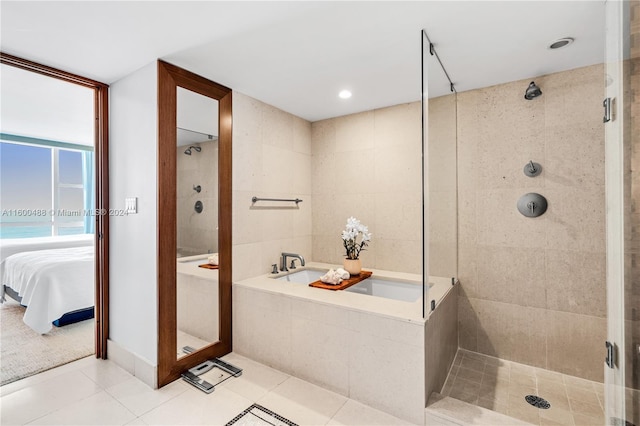 bathroom featuring tile patterned flooring and shower with separate bathtub