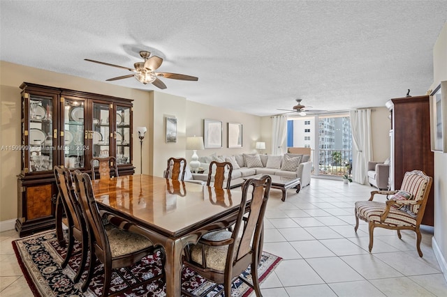 dining area featuring a textured ceiling, ceiling fan, and light tile floors