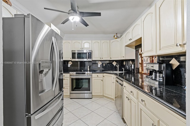 kitchen with stainless steel appliances, backsplash, sink, ceiling fan, and light tile floors