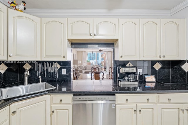 kitchen featuring tasteful backsplash, stainless steel dishwasher, ornamental molding, sink, and cream cabinetry