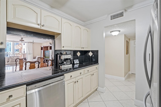 kitchen with backsplash, appliances with stainless steel finishes, light tile flooring, and crown molding