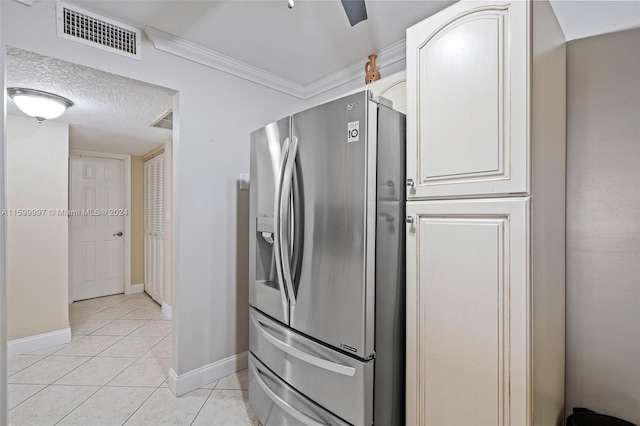 kitchen featuring white cabinetry, a textured ceiling, ornamental molding, stainless steel refrigerator with ice dispenser, and light tile floors