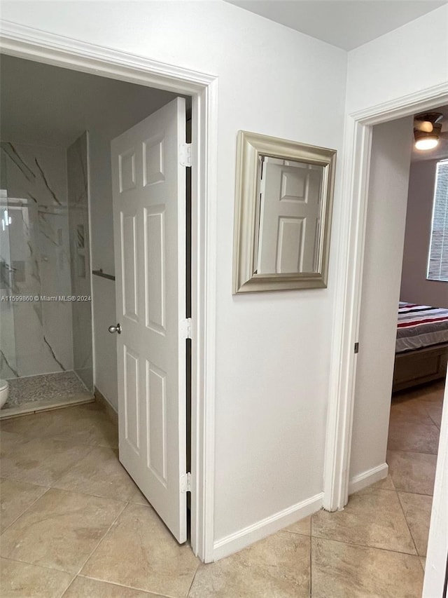 corridor featuring light tile flooring