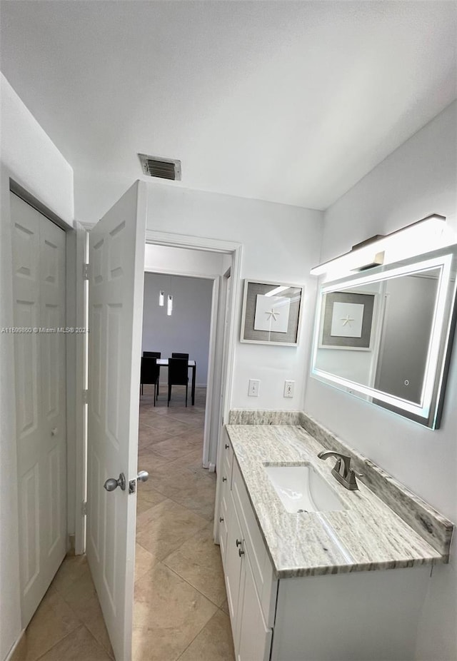 bathroom with tile floors and large vanity