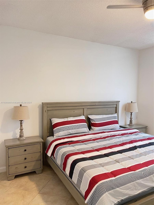 tiled bedroom with a textured ceiling