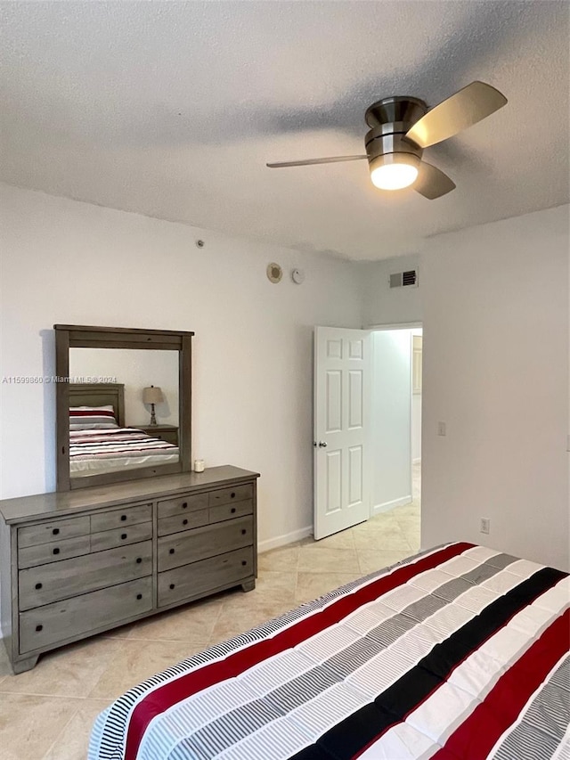 bedroom with ceiling fan and light tile floors