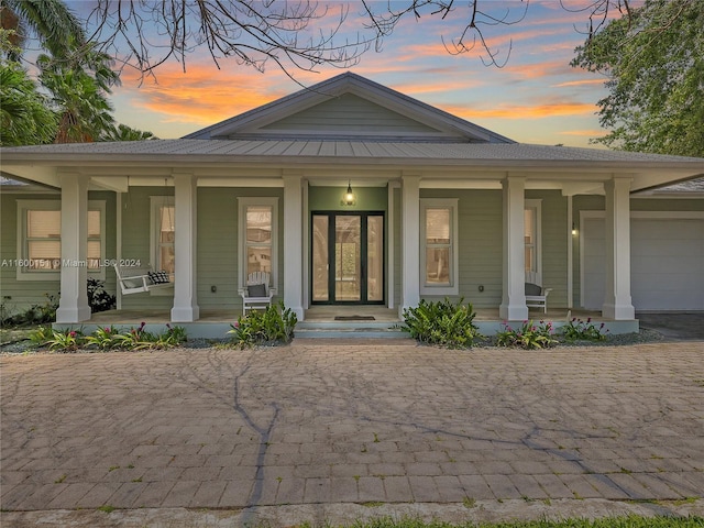 view of front of house featuring a porch and a garage