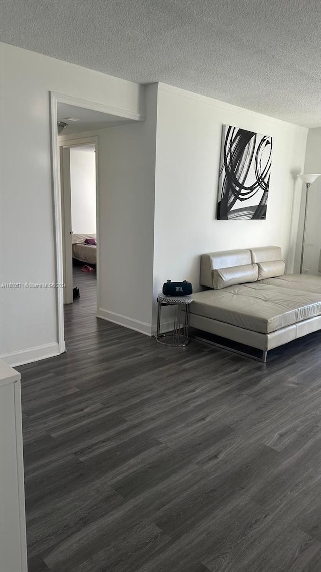 interior space with dark wood-type flooring and a textured ceiling