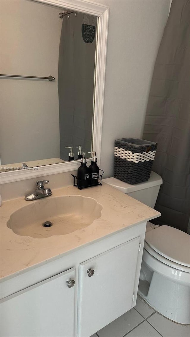 bathroom with vanity, tile patterned floors, and toilet