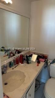 bathroom featuring toilet, tile patterned flooring, and vanity